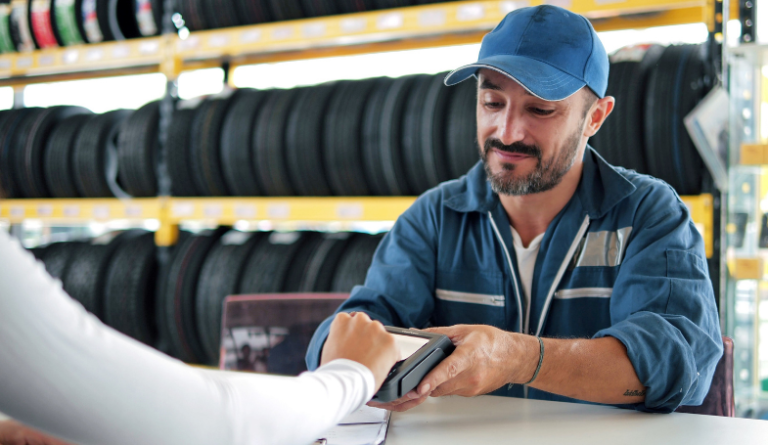 Consumer paying at tire shop – Consumer expenditure